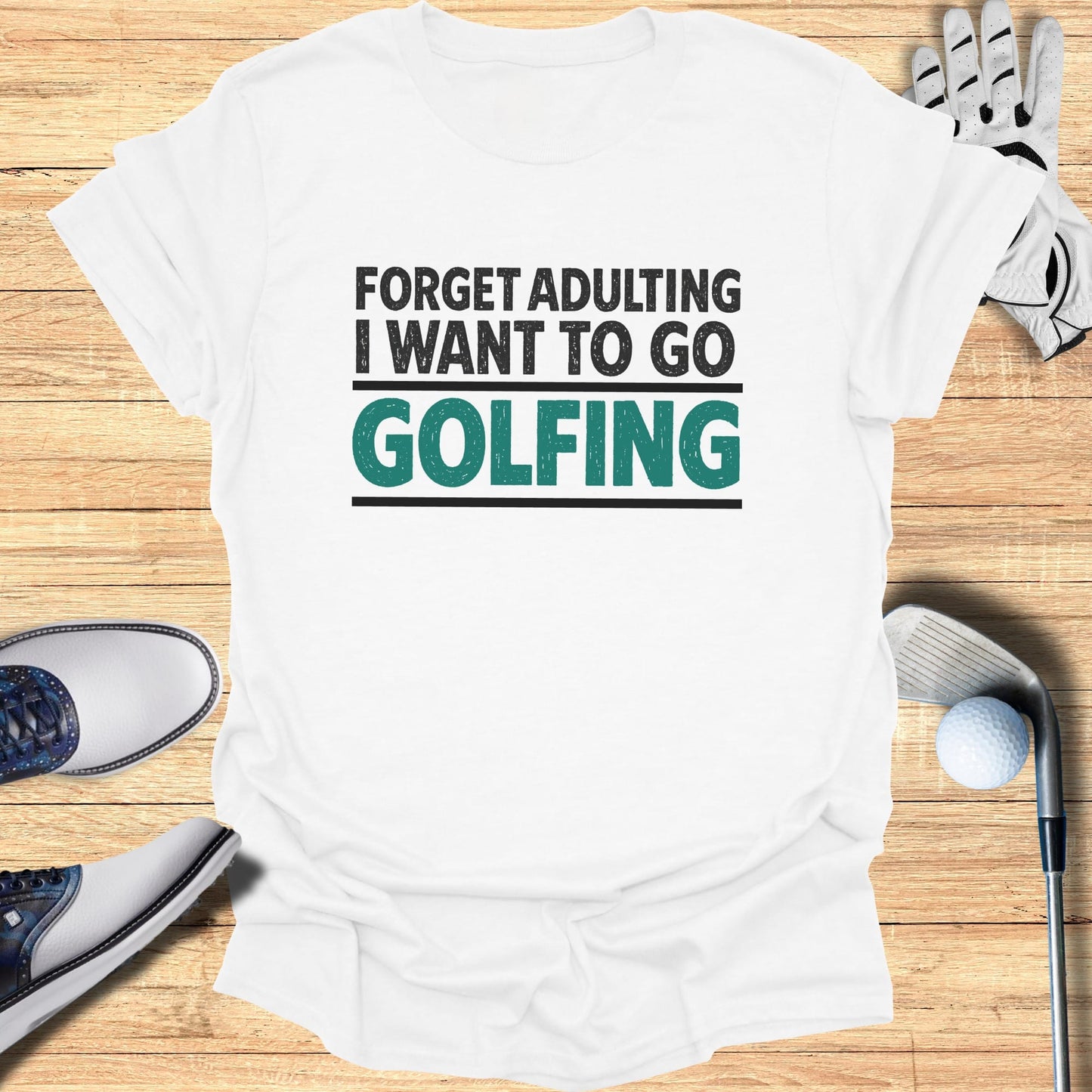 White t-shirt with "Forget Adulting I Want To Go Golfing" text in black and teal.