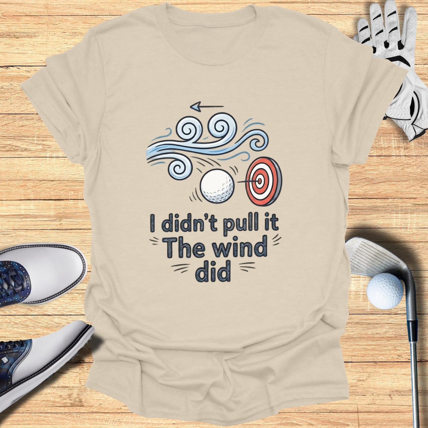 T-shirt with text "I didn't pull the wind did" and golf imagery.