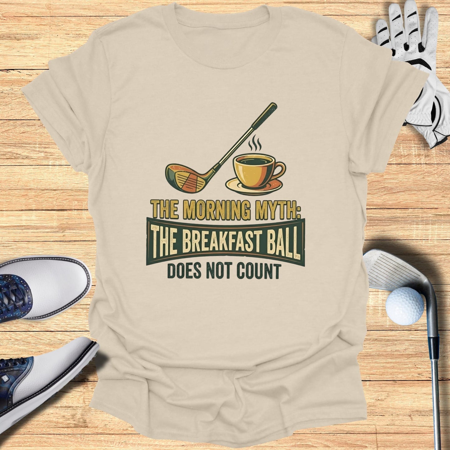T-shirt with golf club, coffee cup, and text: The Morning Myth: The Breakfast Ball Does Not Count
