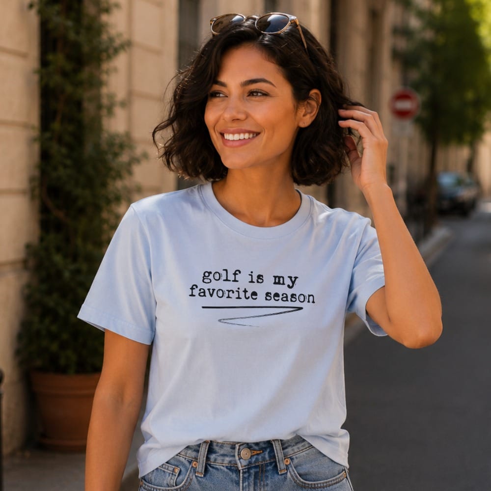 Light blue t-shirt with "golf is my favorite season" text and a woman wearing it.