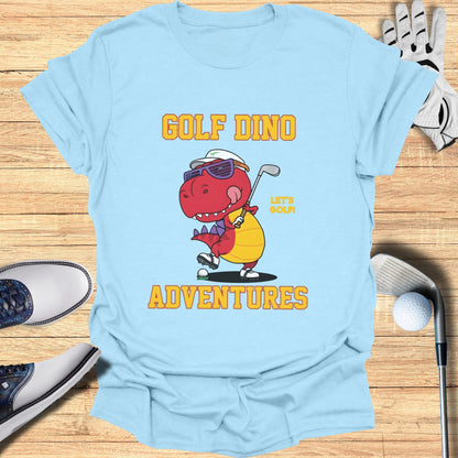 Light blue t-shirt with a cartoon dinosaur wearing sunglasses and playing golf.