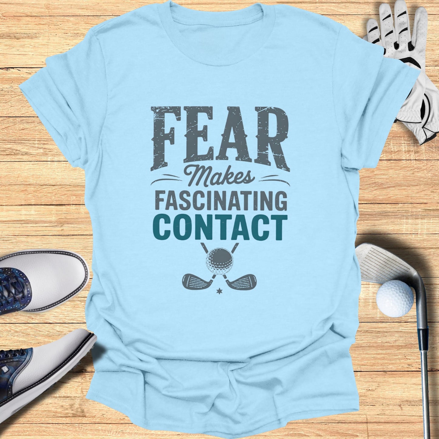 Light blue t-shirt with "FEAR MAKES FASCINATING CONTACT" and golf graphics.