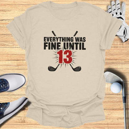 T-shirt with text "EVERYTHING WAS FINE UNTIL 13" and crossed golf clubs.