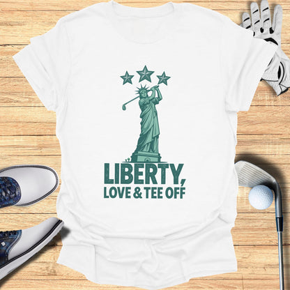 Statue of Liberty swinging a golf club with text "LIBERTY, LOVE & TEE OFF".