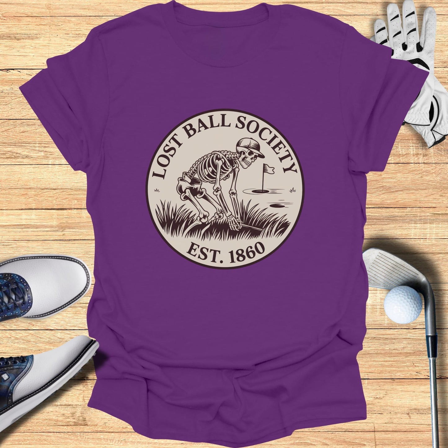 Purple t-shirt with skeleton golfing graphic and "Lost Ball Society Est. 1860" text.