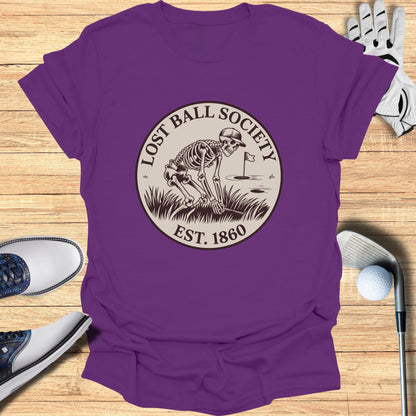 Purple t-shirt with skeleton golfing graphic and "Lost Ball Society Est. 1860" text.