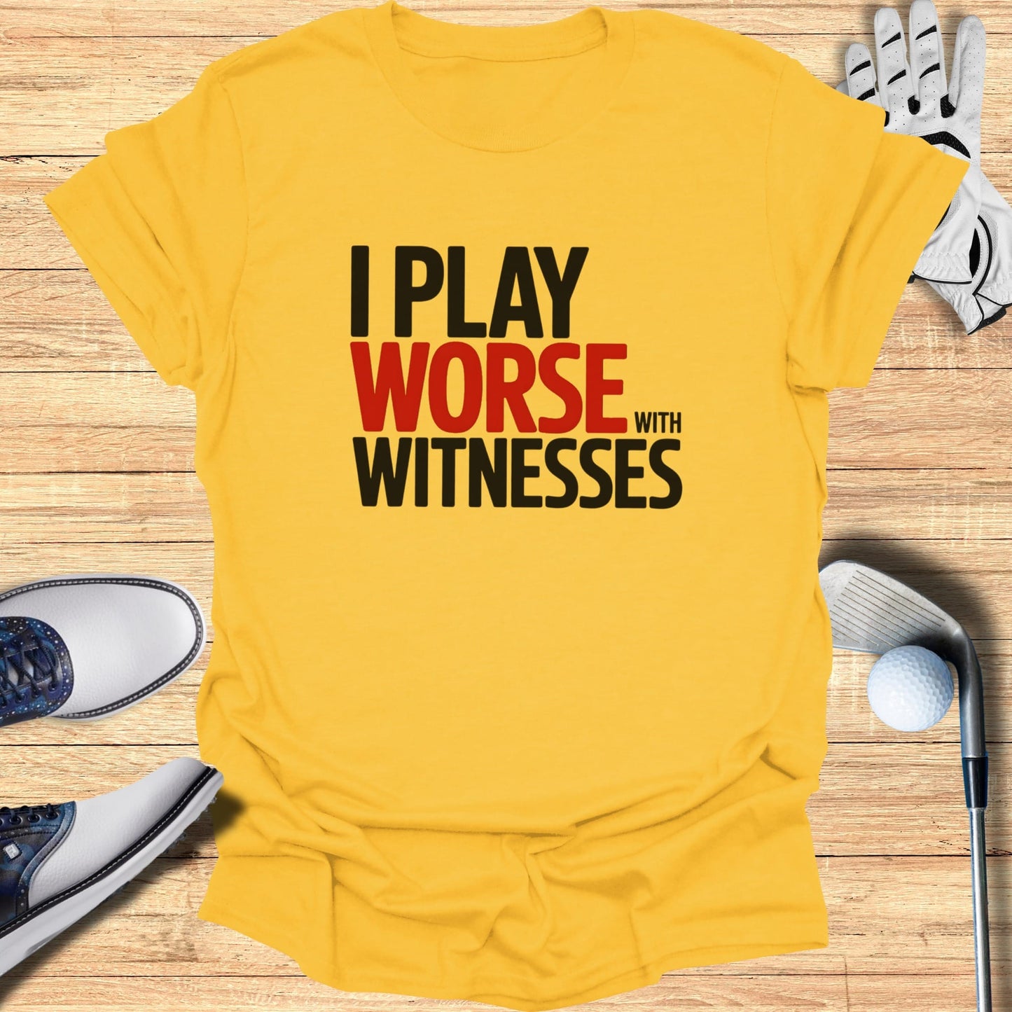 Yellow t-shirt with black and red text "I PLAY WORSE WITH WITNESSES".