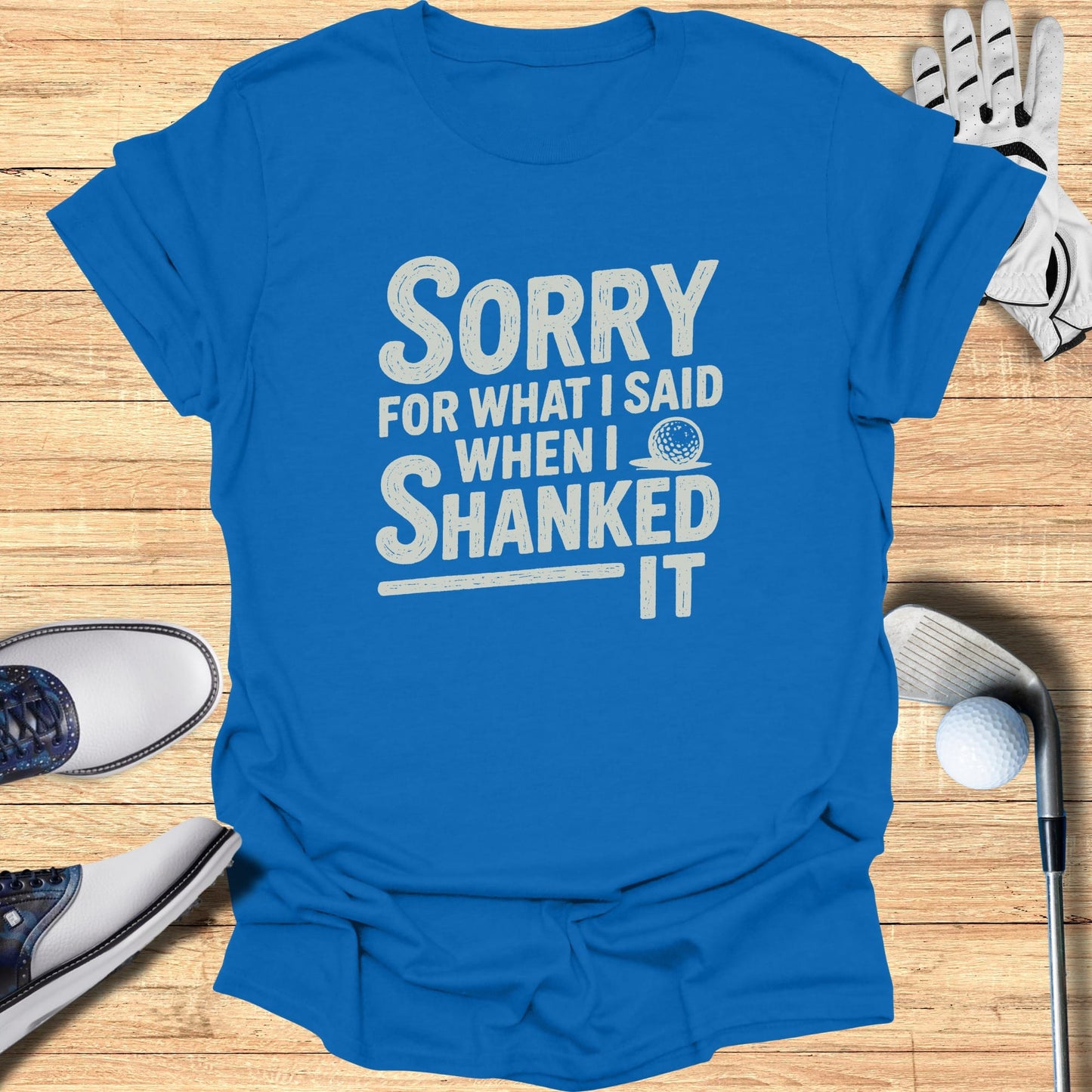 Blue t-shirt with white text reading "Sorry when I shanked it."
