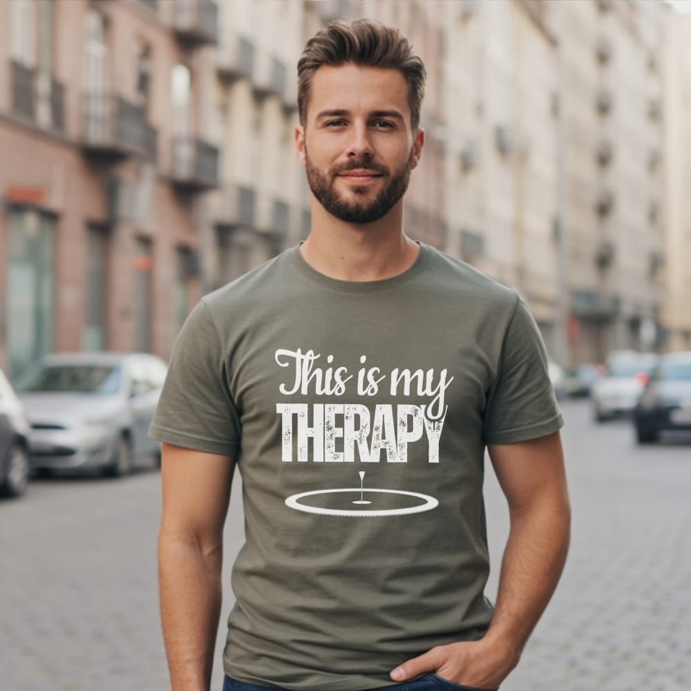 Man in olive t-shirt with "This is my THERAPY" golf graphic.