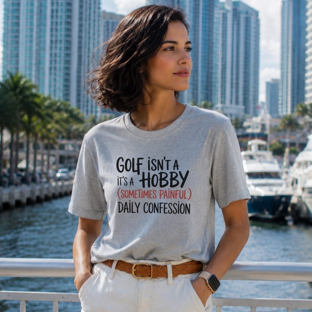 Gray t-shirt with "Golf isn't a hobby" text, worn by a woman.