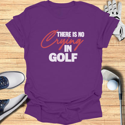 Purple t-shirt with "There is no crying in golf" text, golf shoes, and club.