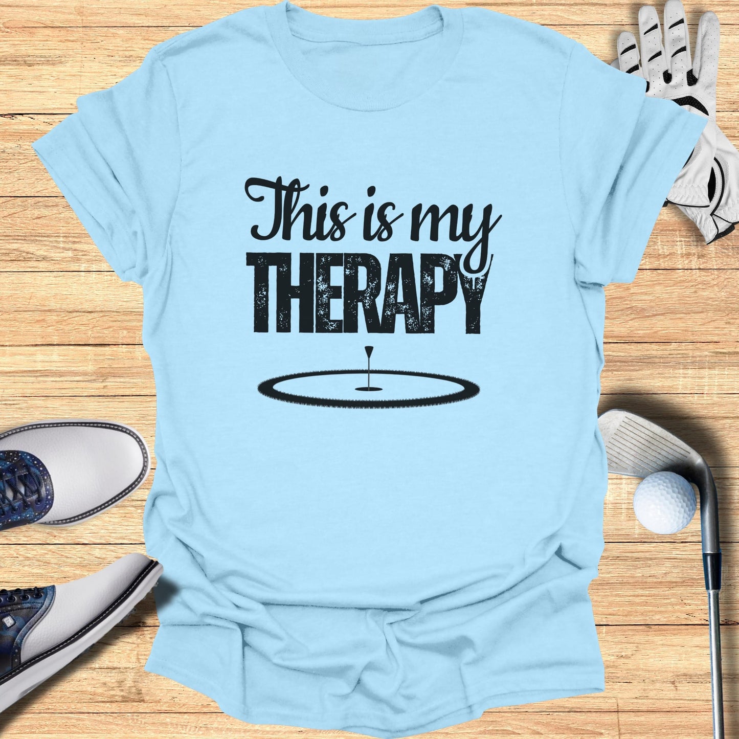 Light blue t-shirt with "This is my THERAPY" and a golf hole graphic.