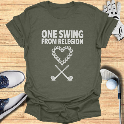Olive green t-shirt with text "ONE SWING FROM RELIGION" and golf club graphic.
