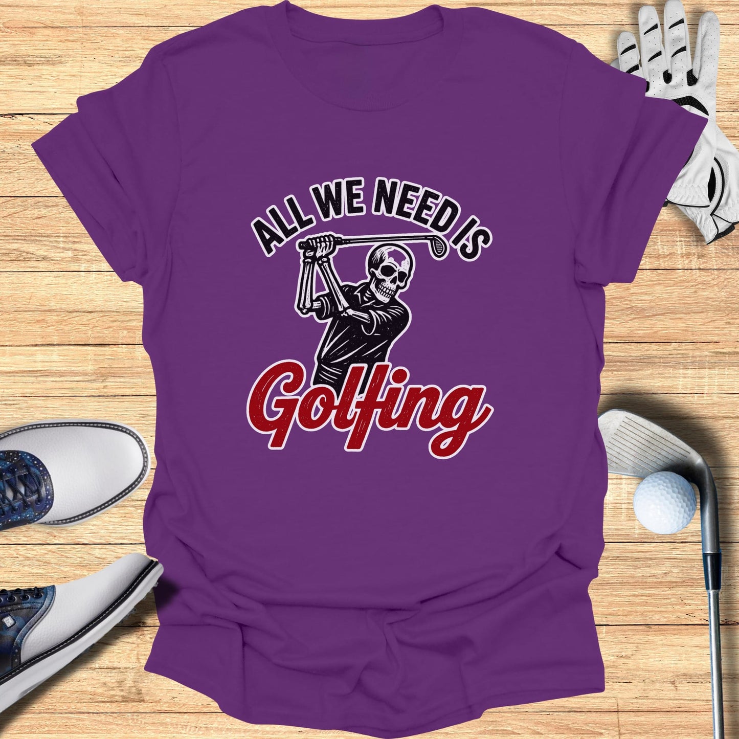 Purple t-shirt with skeleton golfer and "All We Need is Golfing" text.