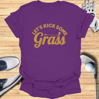 Purple t-shirt with yellow text reading "Let's Kick Some Grass".