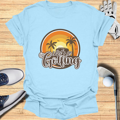 Light blue t-shirt with "Let's Go Golfing" text and a sunset graphic.