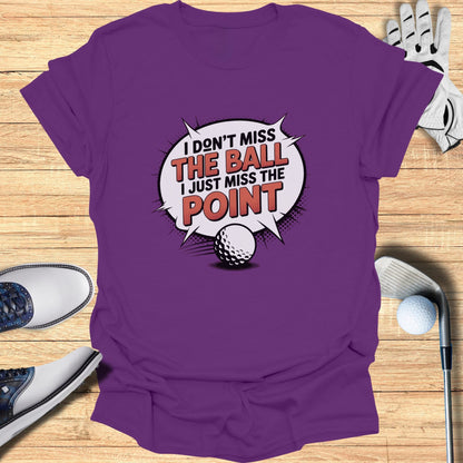 Purple t-shirt with "I don't miss the ball, I just miss the point" graphic.