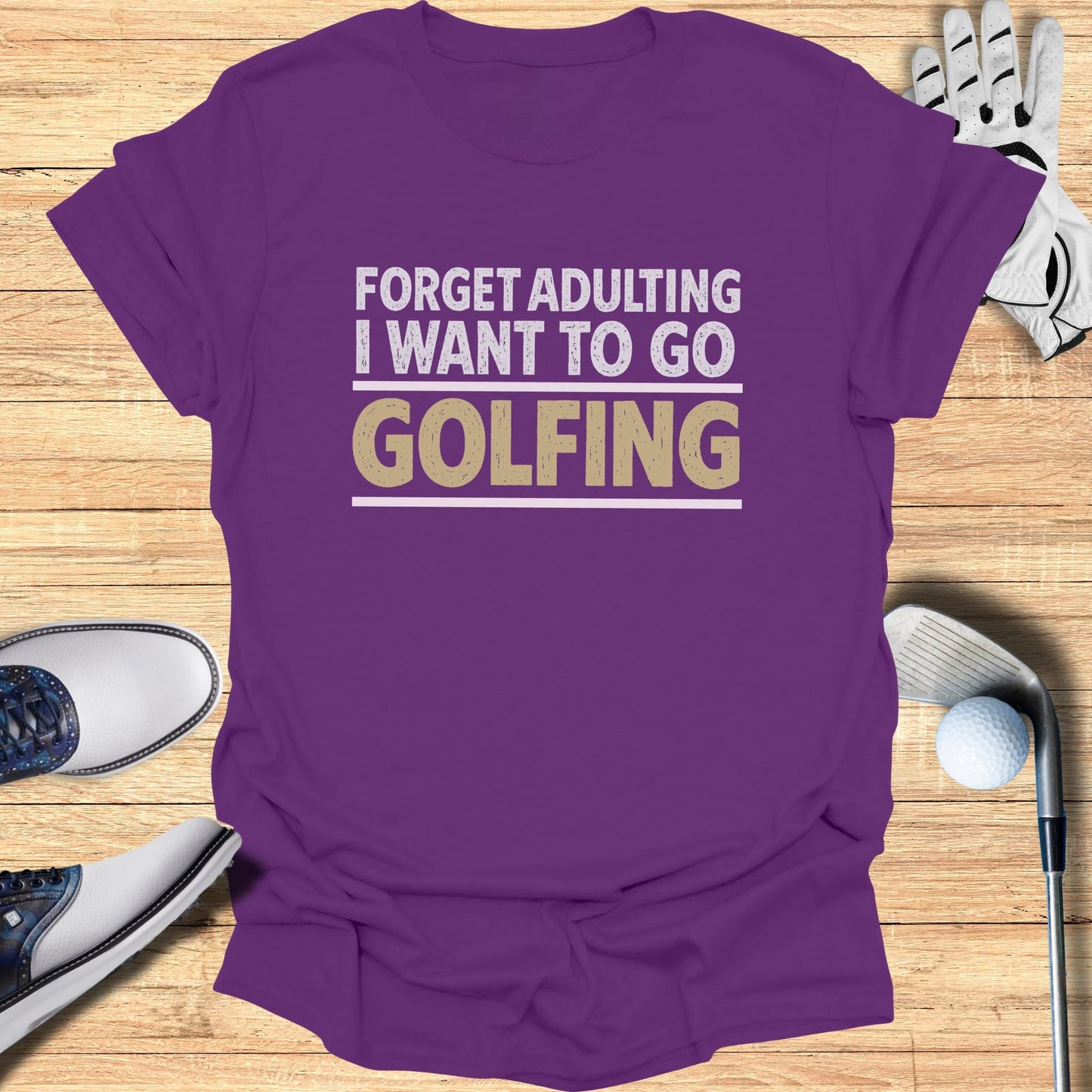 Purple t-shirt with "Forget adulting I want to go Golfing" text.