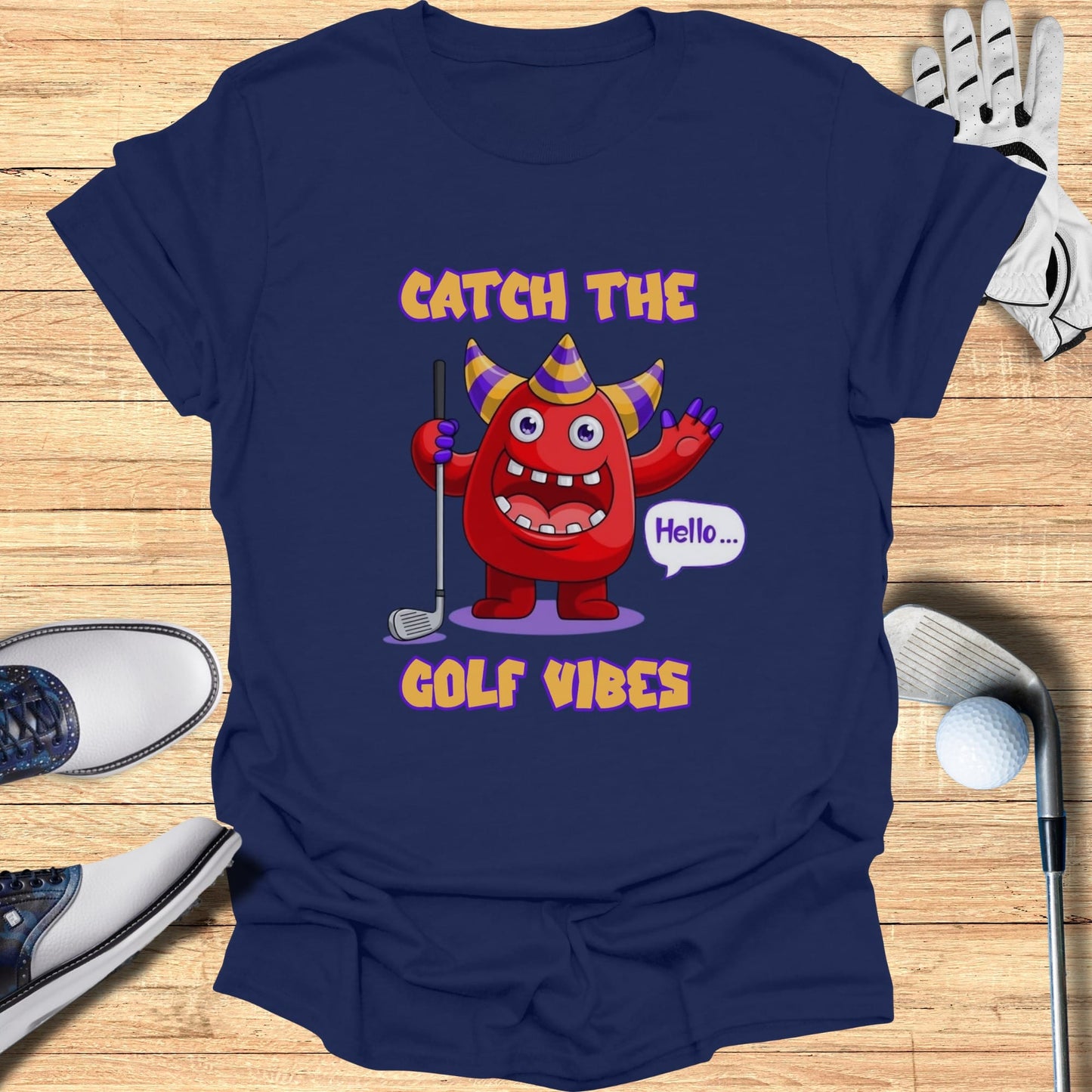 Cartoon monster in party hat saying "Hello" on a navy t-shirt with "GOLF VIBES".