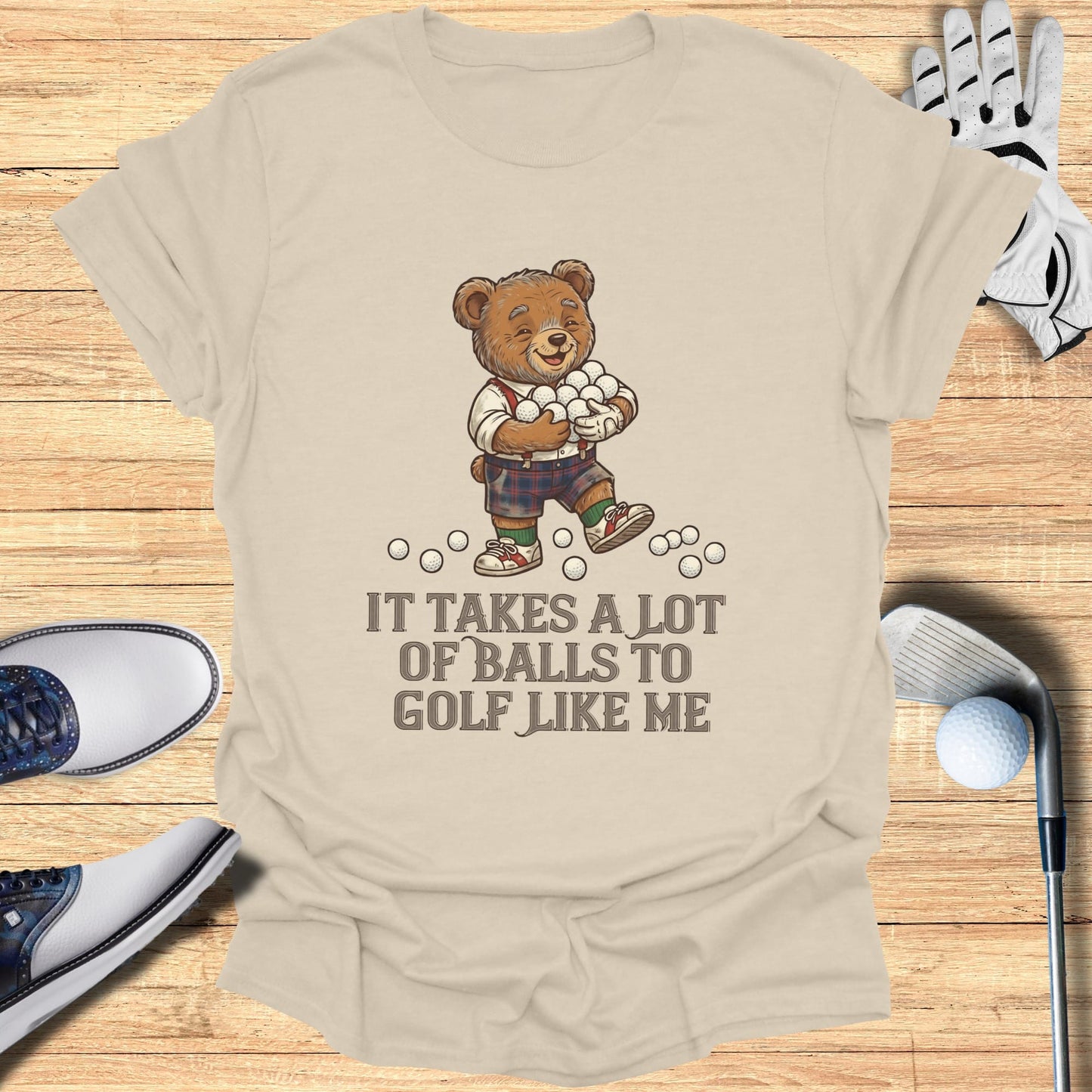 Bear holding golf balls with text "It takes a lot of balls to golf like me".