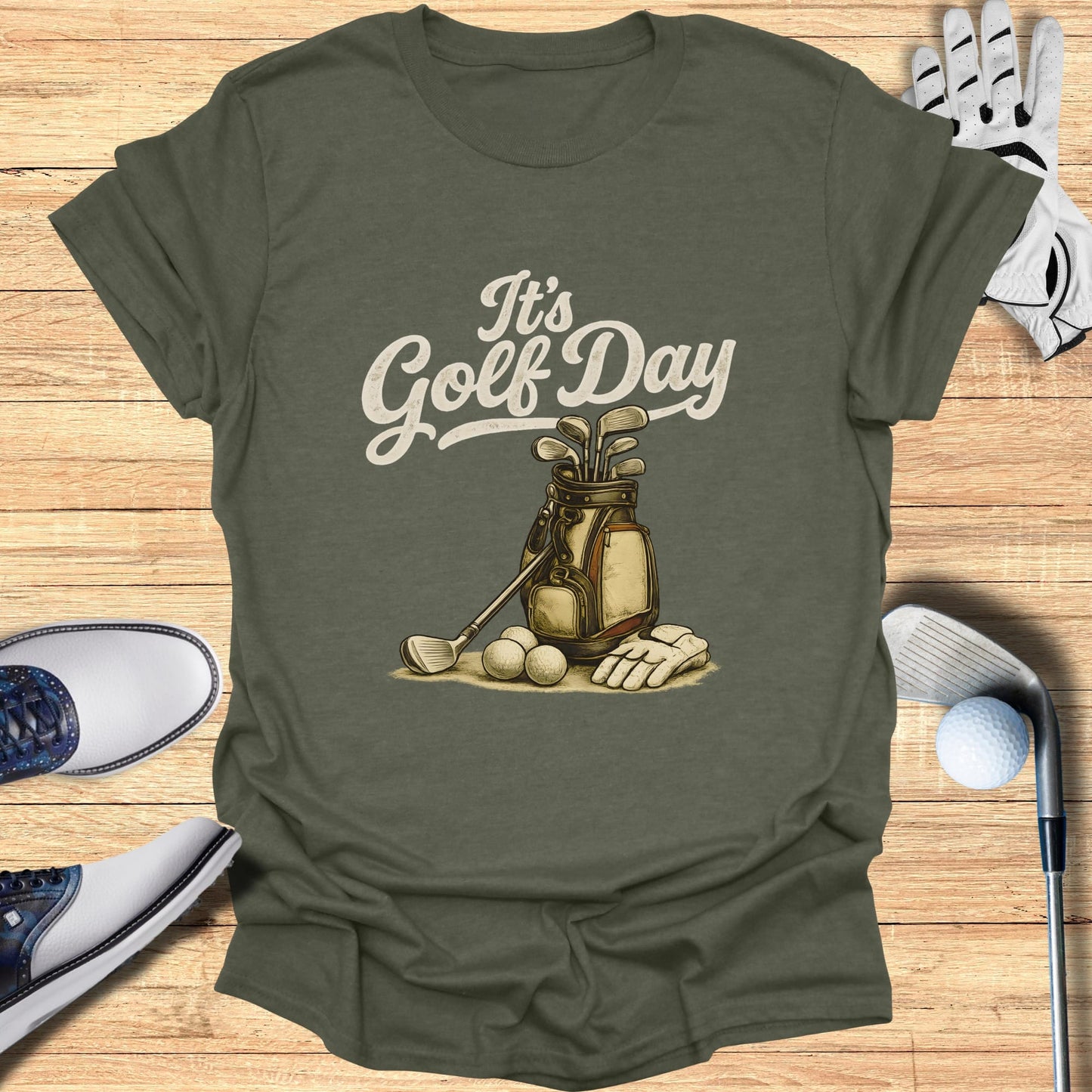 Olive green t-shirt with "It's Golf Day" text and golf bag with clubs.