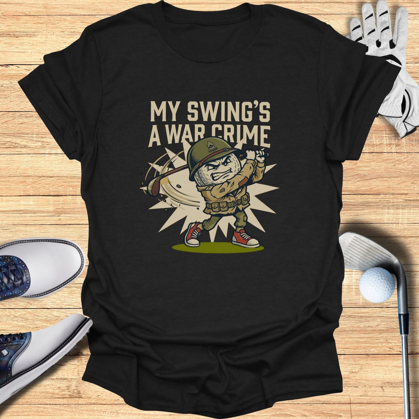 T-shirt graphic of a cartoon soldier swinging a golf club with text "MY SWING'S A WAR CRIME".