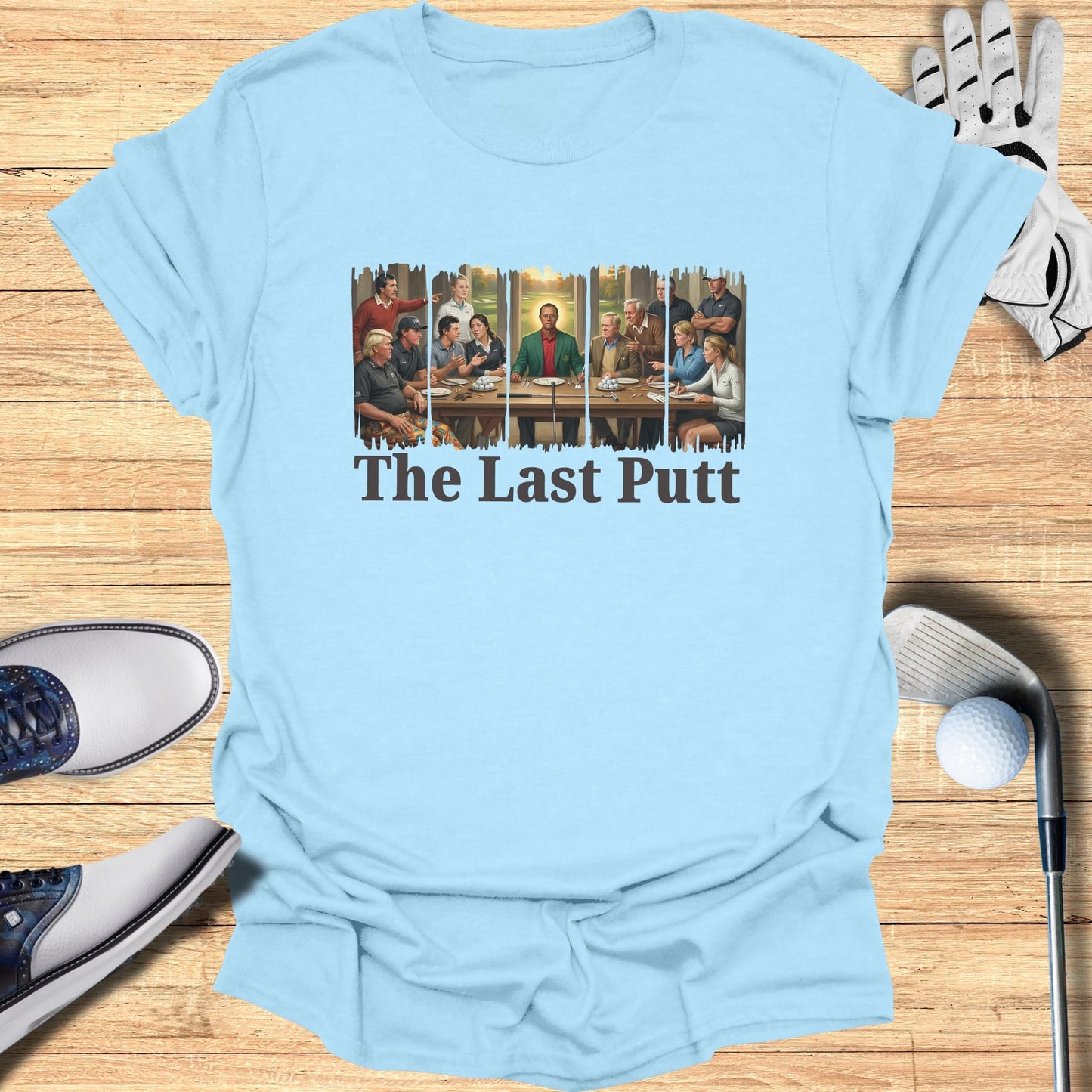 Light blue t-shirt with "The Last Putt" text and a drawing of men playing golf.