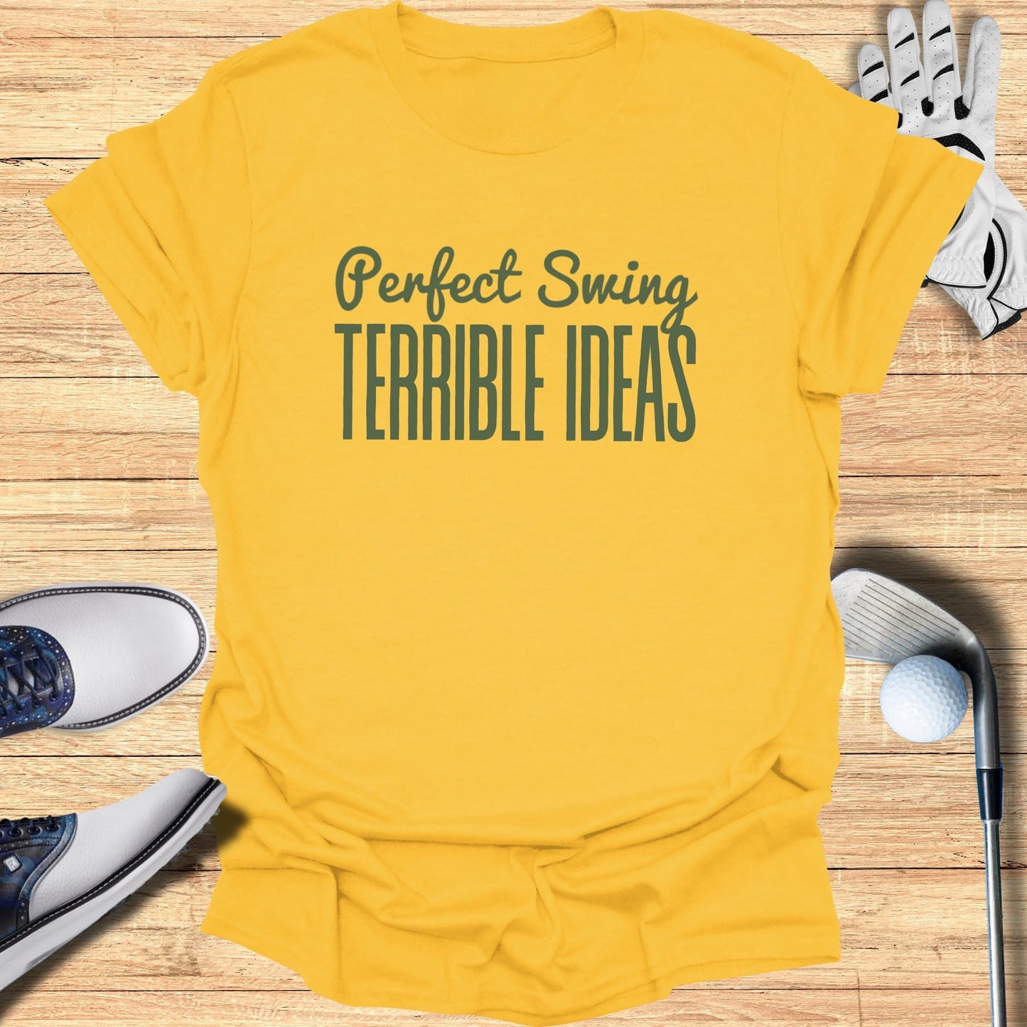 Yellow t-shirt with "Perfect Swing TERRIBLE IDEAS" text, golf accessories.