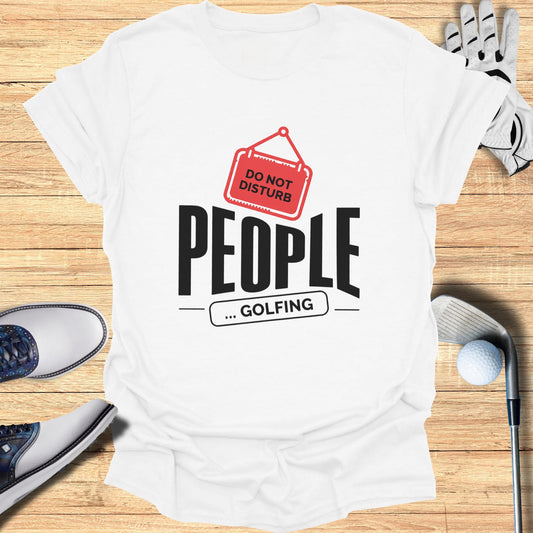 White t-shirt with "DO NOT DISTURB ... GOLFING" text, golf clubs, and shoes.