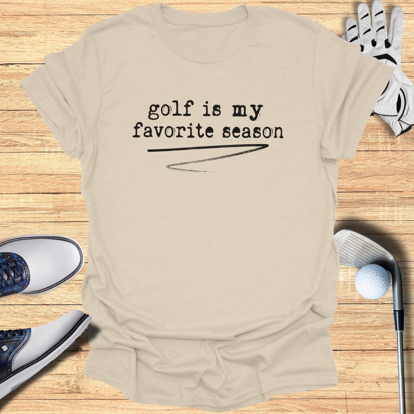 Cream t-shirt with "golf is my favorite season" text, golf club, glove, and shoes.