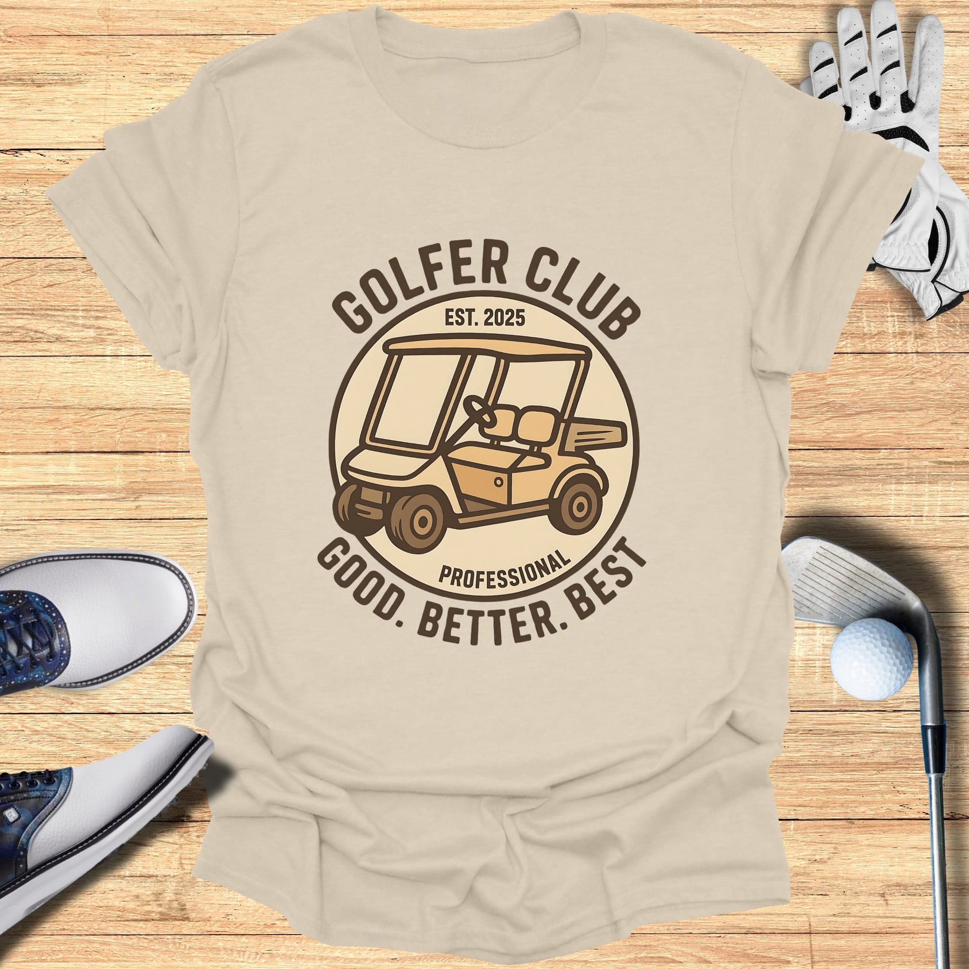 Golf cart and "Golfer Club" text on a beige t-shirt with golf equipment.