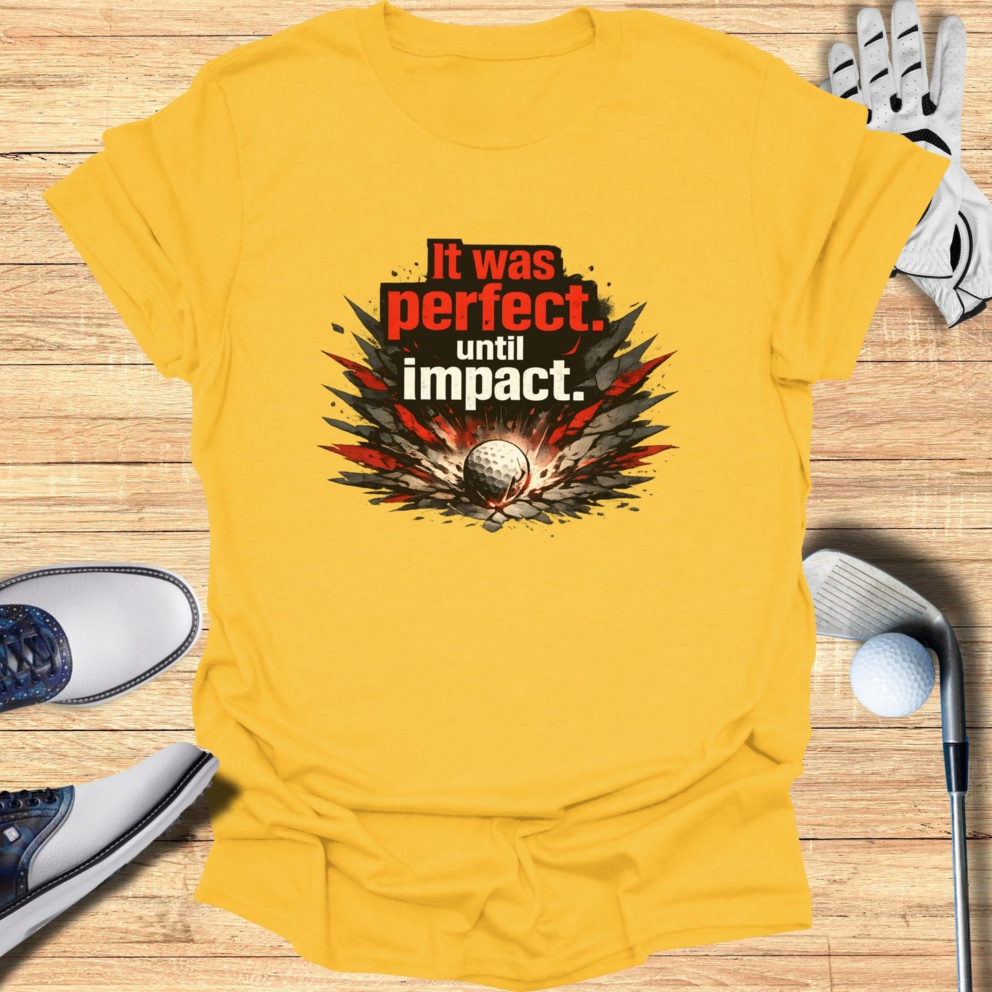 Yellow t-shirt with "It was perfect, until impact." text and golf ball graphic.