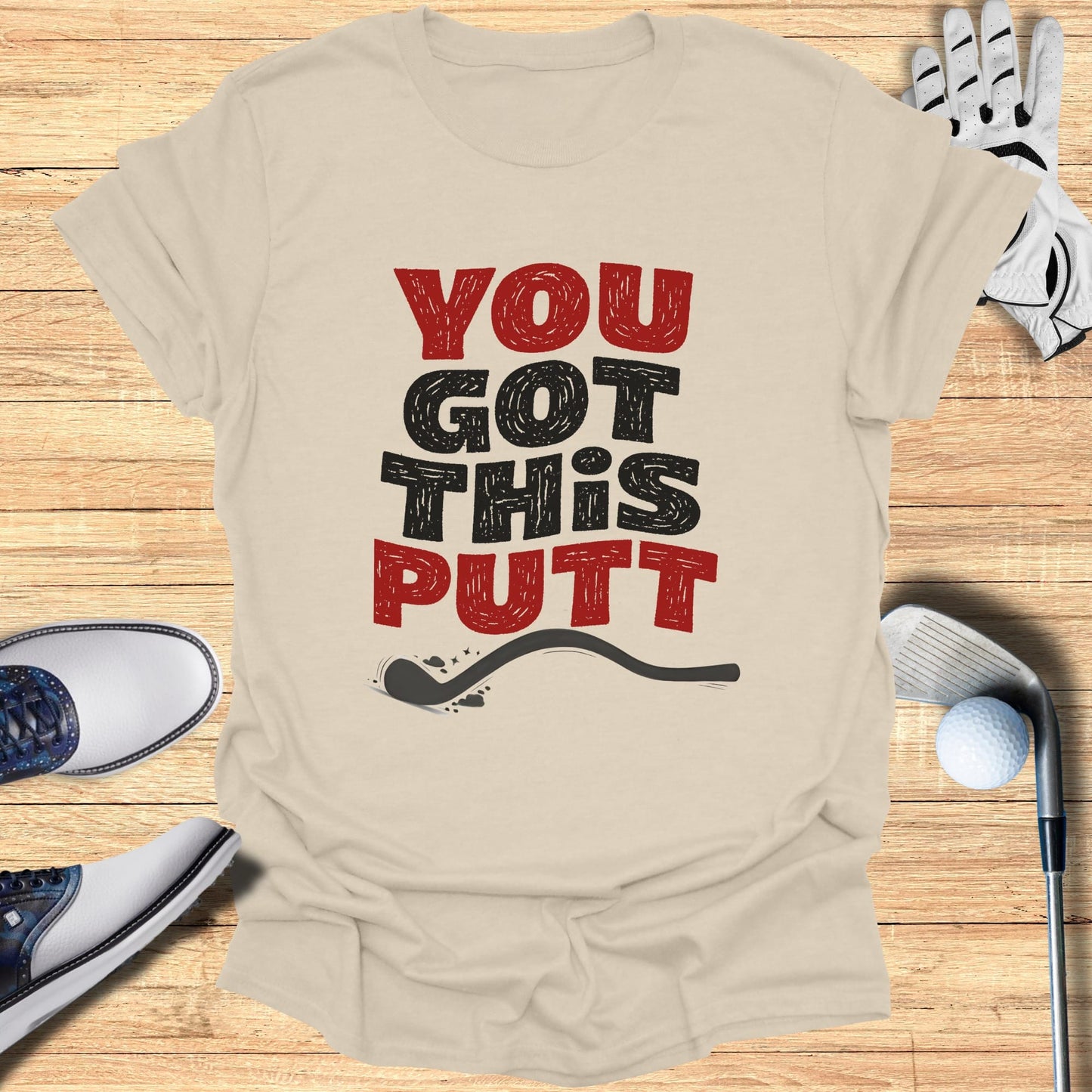 Beige t-shirt with "YOU GOT THIS PUTT" text and golf accessories.