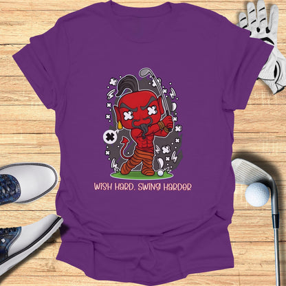 Devil character swinging a golf club with text "Wish Hard. Swing Harder."