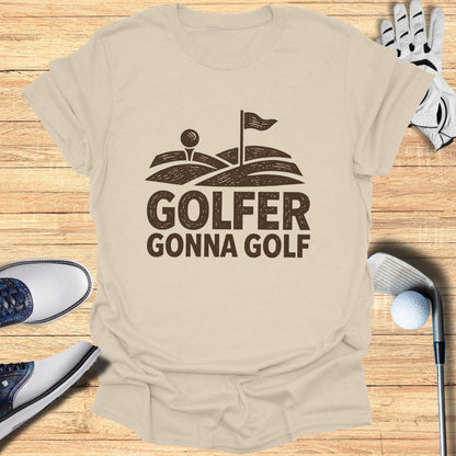 GOLFER GONNA GOLF text design on a tan t-shirt with golf equipment.