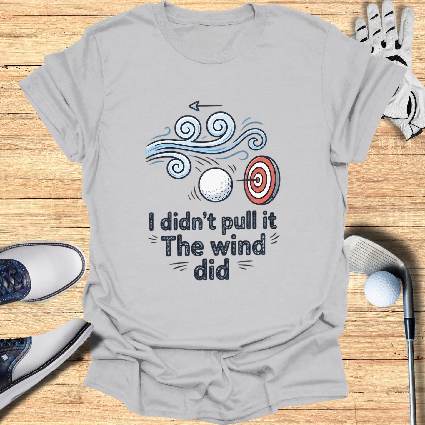 T-shirt with golf ball, target, and text "I didn't pull the wind did".