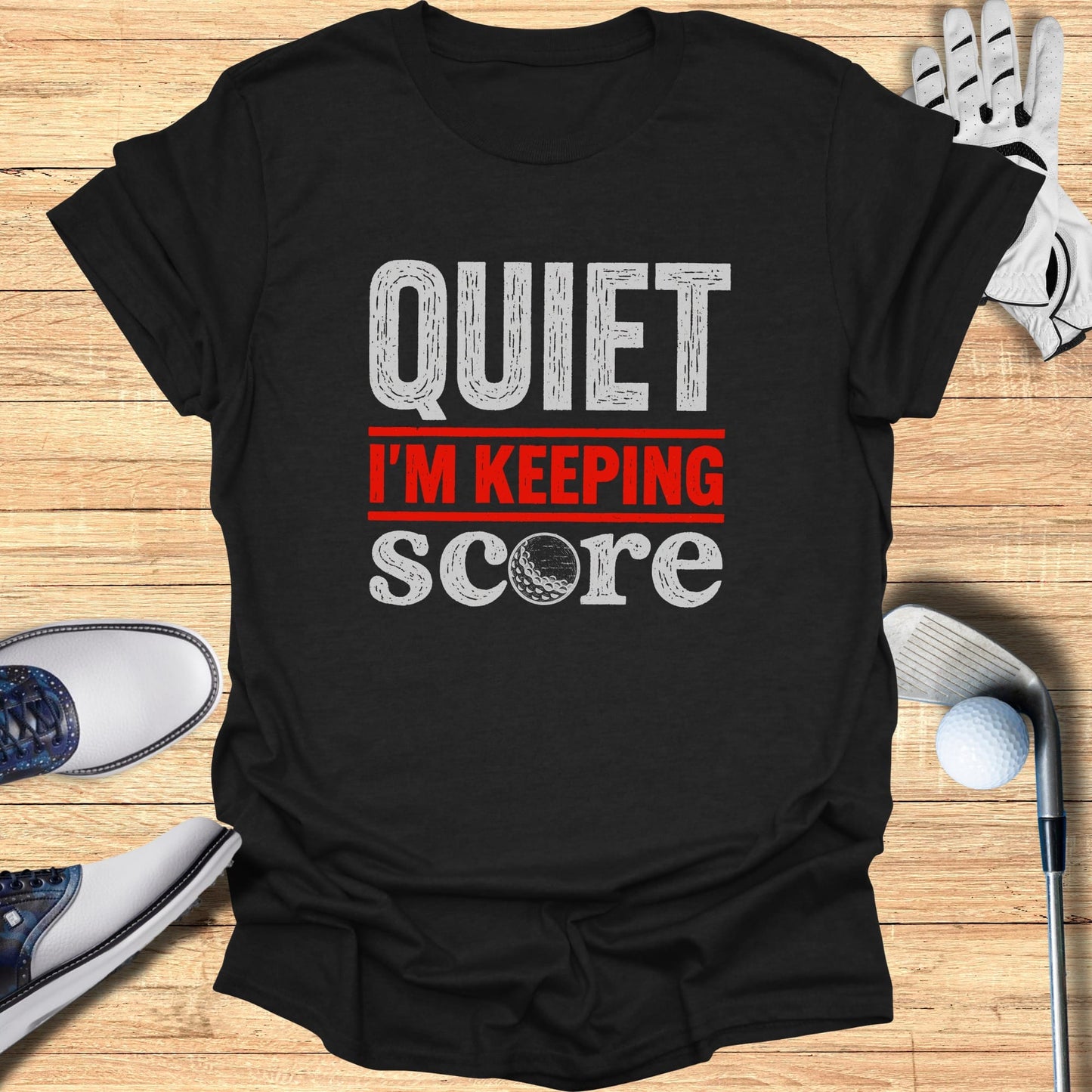 Black t-shirt with "QUIET I'M KEEPING SCORE" text and golf accessories.