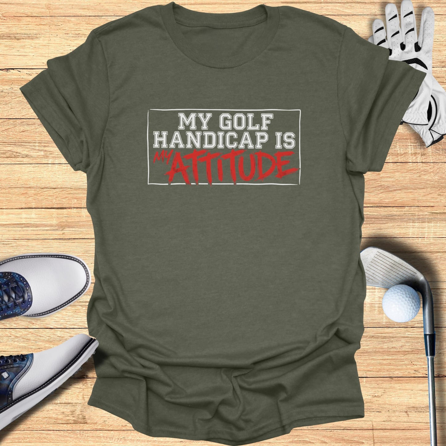 T-shirt with "MY GOLF HANDICAP IS ATTITUDE" text and golf accessories.