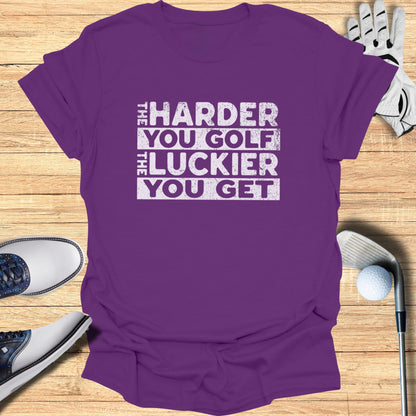 Purple t-shirt with "The Harder You Golf, The Luckier You Get" text.