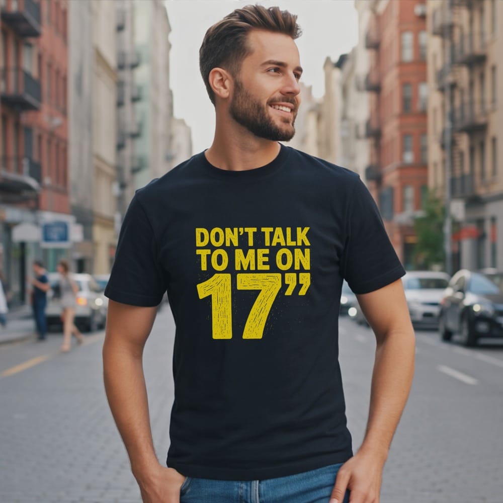 Man wearing a dark t-shirt with yellow text "Don't talk to me on 17".