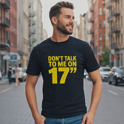 Man wearing a dark t-shirt with yellow text "Don't talk to me on 17".