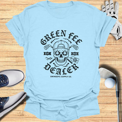 Light blue t-shirt with "Green Fee Dealer" skull graphic, EST. 2026, and "Price: One More Round."