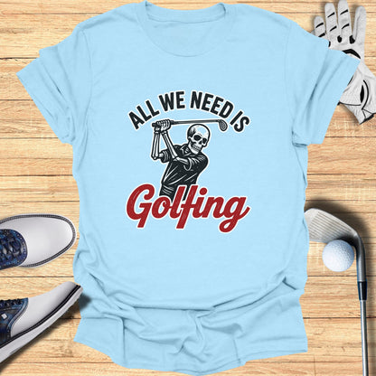 Light blue t-shirt with skeleton golfer graphic and "All We Need Is Golfing" text.
