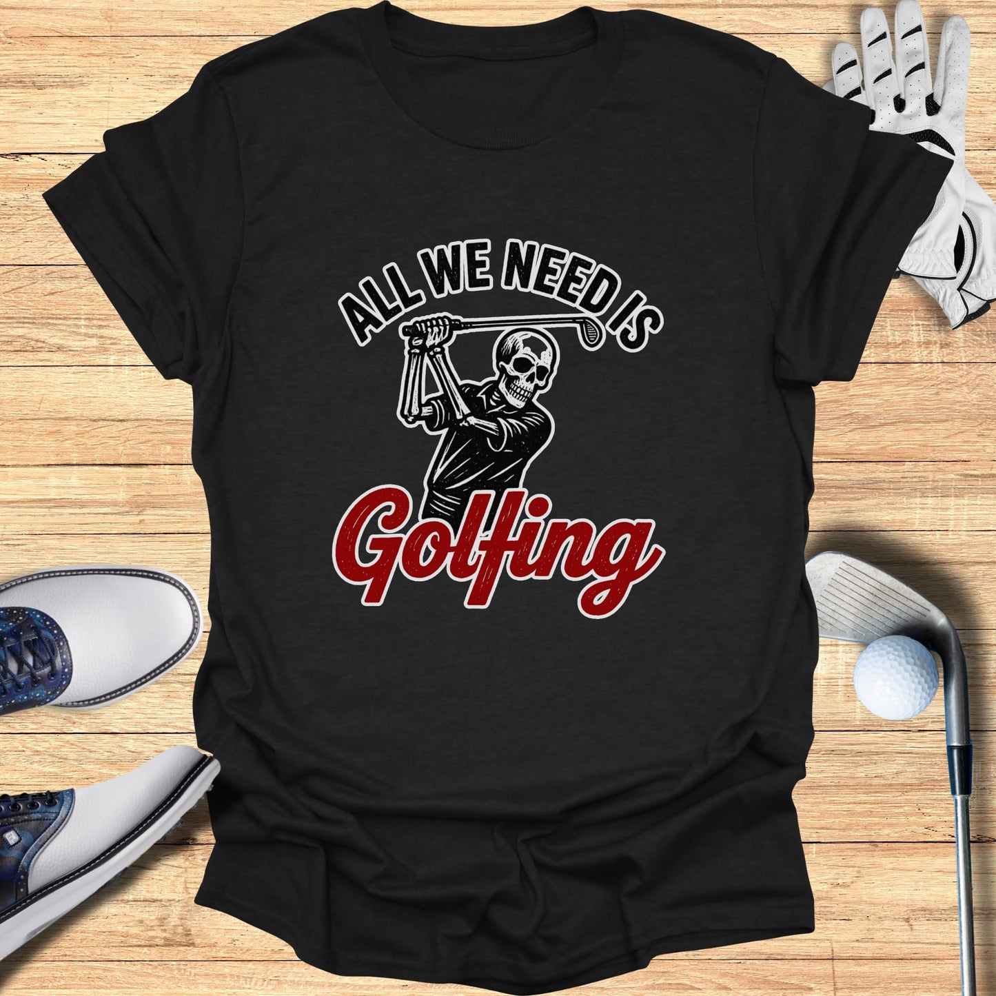 Black t-shirt with "All We Need Is Golfing" and skeleton golfer graphic.