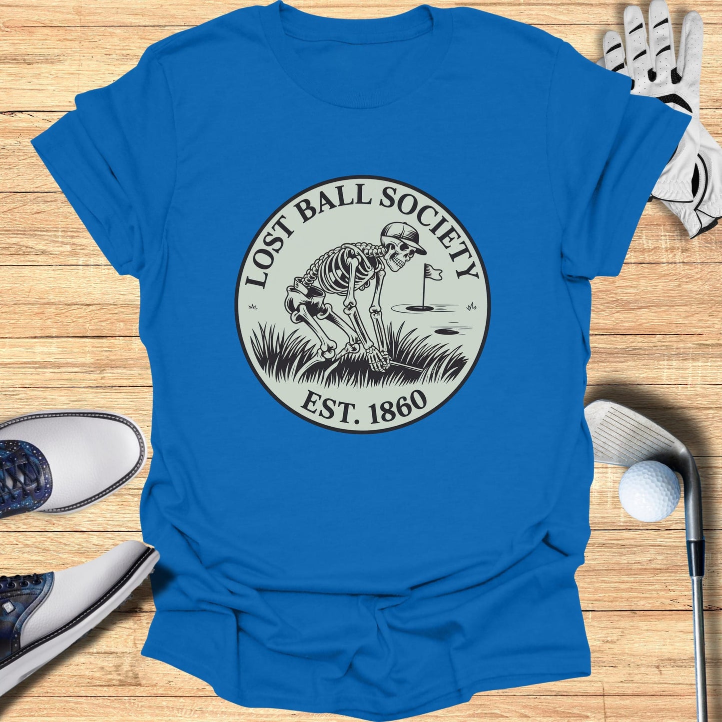Blue t-shirt with Lost Ball Society Est. 1860 skeleton golf logo.