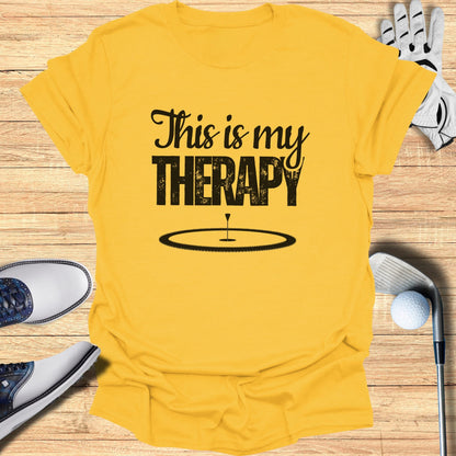 Yellow t-shirt with "This is my THERAPY" and golf hole graphic.