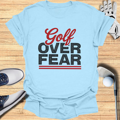 Light blue t-shirt with "Golf Over Fear" text design.