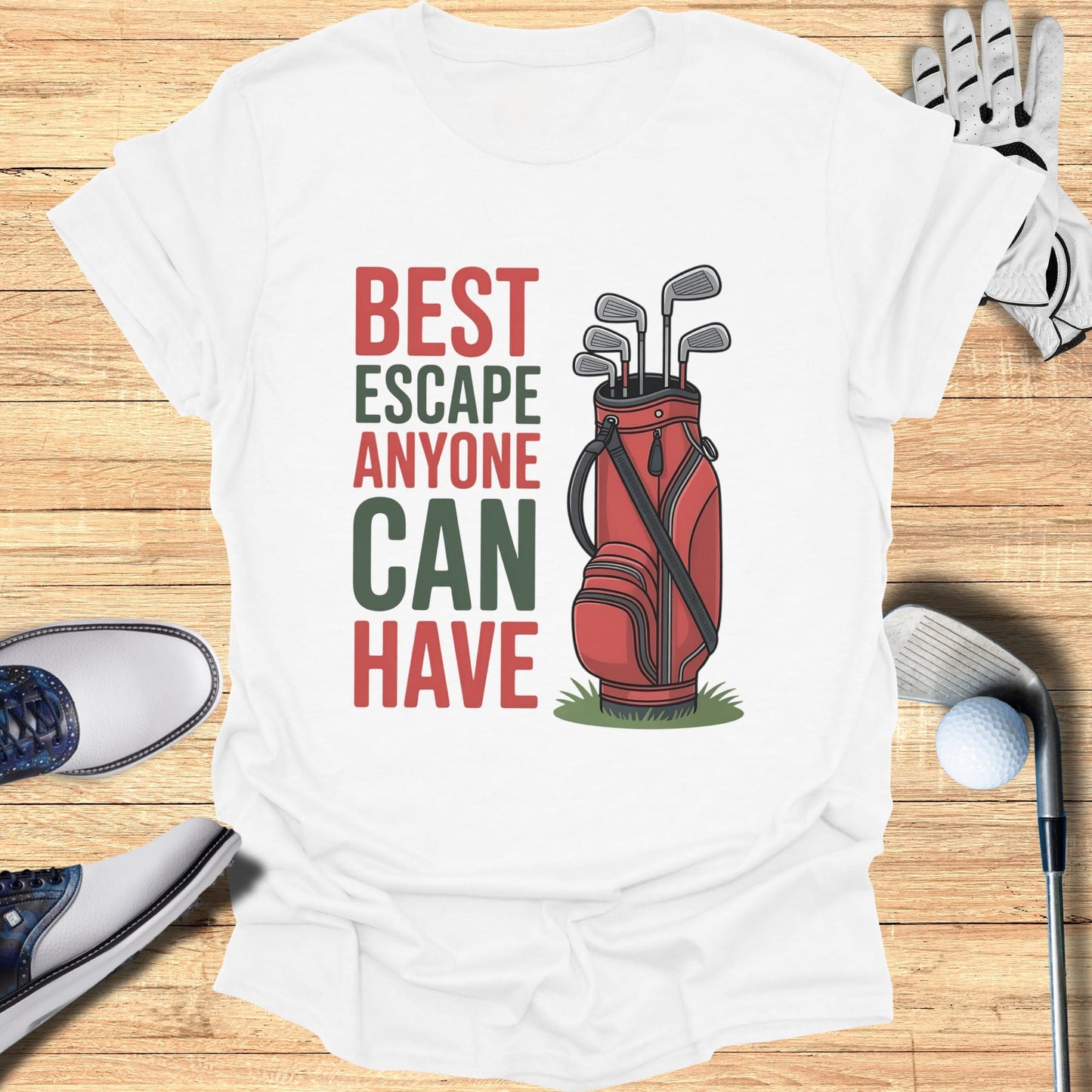 White t-shirt with red and green text "BEST ESCAPE ANYONE CAN HAVE" and a golf bag.