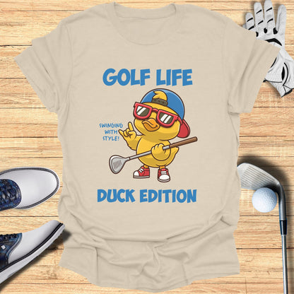 Cream t-shirt with cartoon duck golfer and "GOLF LIFE DUCK EDITION" text.
