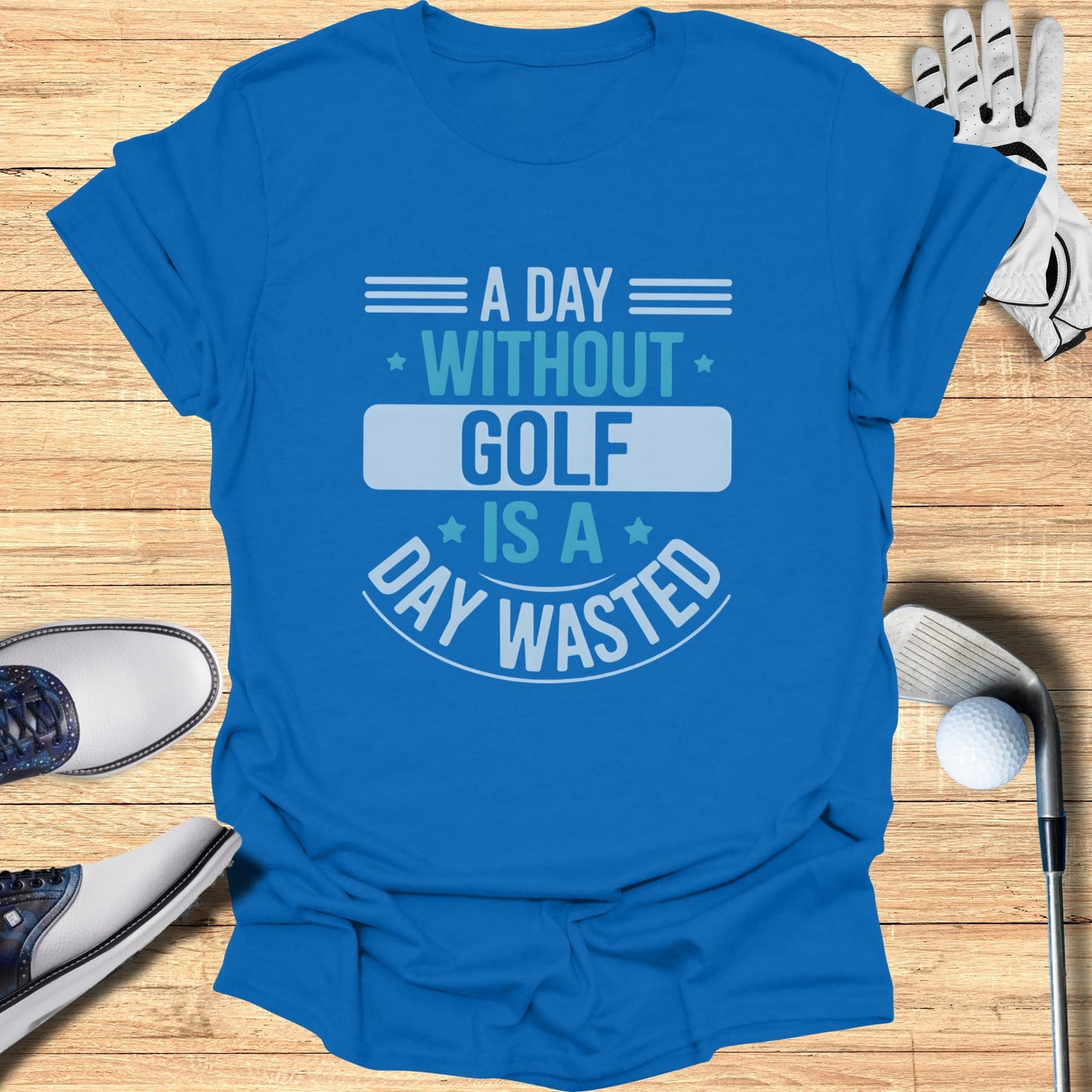 Blue t-shirt with "A day without golf is a day wasted" text.